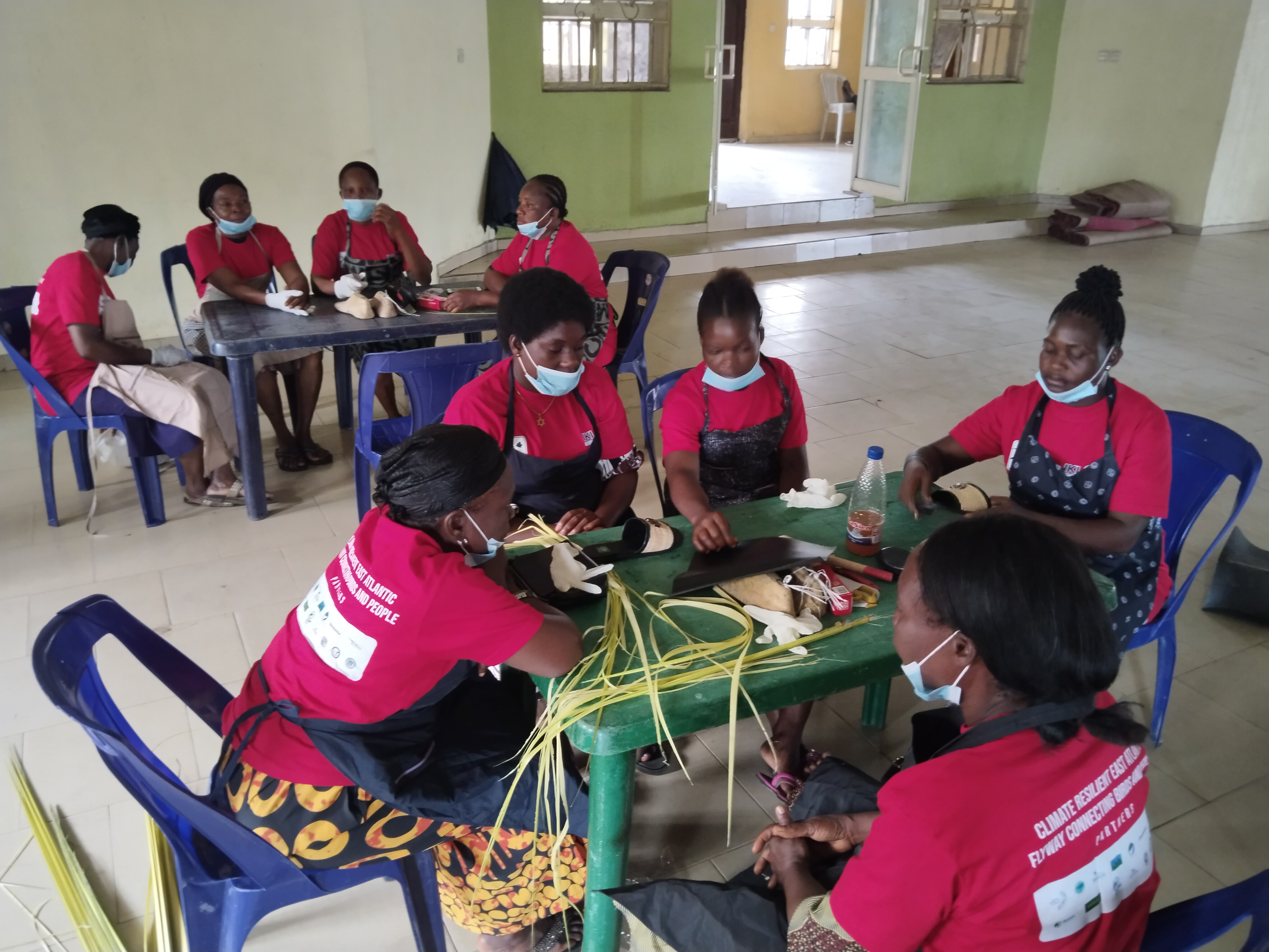 Women learning to weave products from invasive Nipa palm fibres during a training workshop in coastal Nigeria.