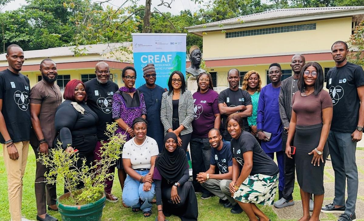 Participants. © NCF. Group photo of Nigerian journalists and workshop organizers during the CREAF journalist training at the Nigerian Conservation Foundation. The diverse group stands in front of a training banner outside.