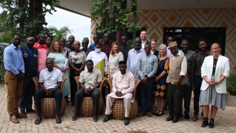 A group of people standing and sitting in rows facing the camera.