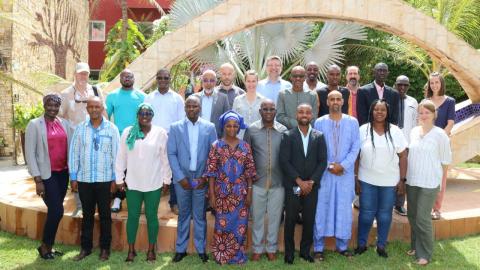 A group of representatives of the project partners standing in 3 rows facing the camera.