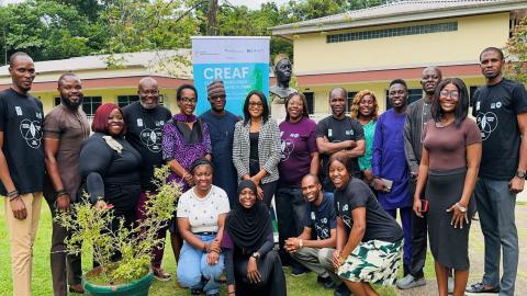 Group photo of Nigerian journalists and workshop organizers during the CREAF journalist training at the Nigerian Conservation Foundation. The diverse group stands in front of a training banner outside. 