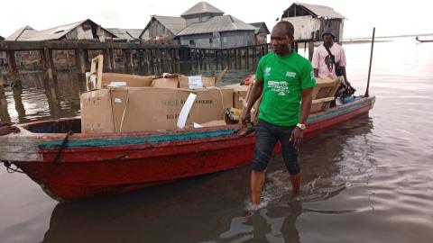 Boat transporting boxed solar freezers to Oyorokoto.